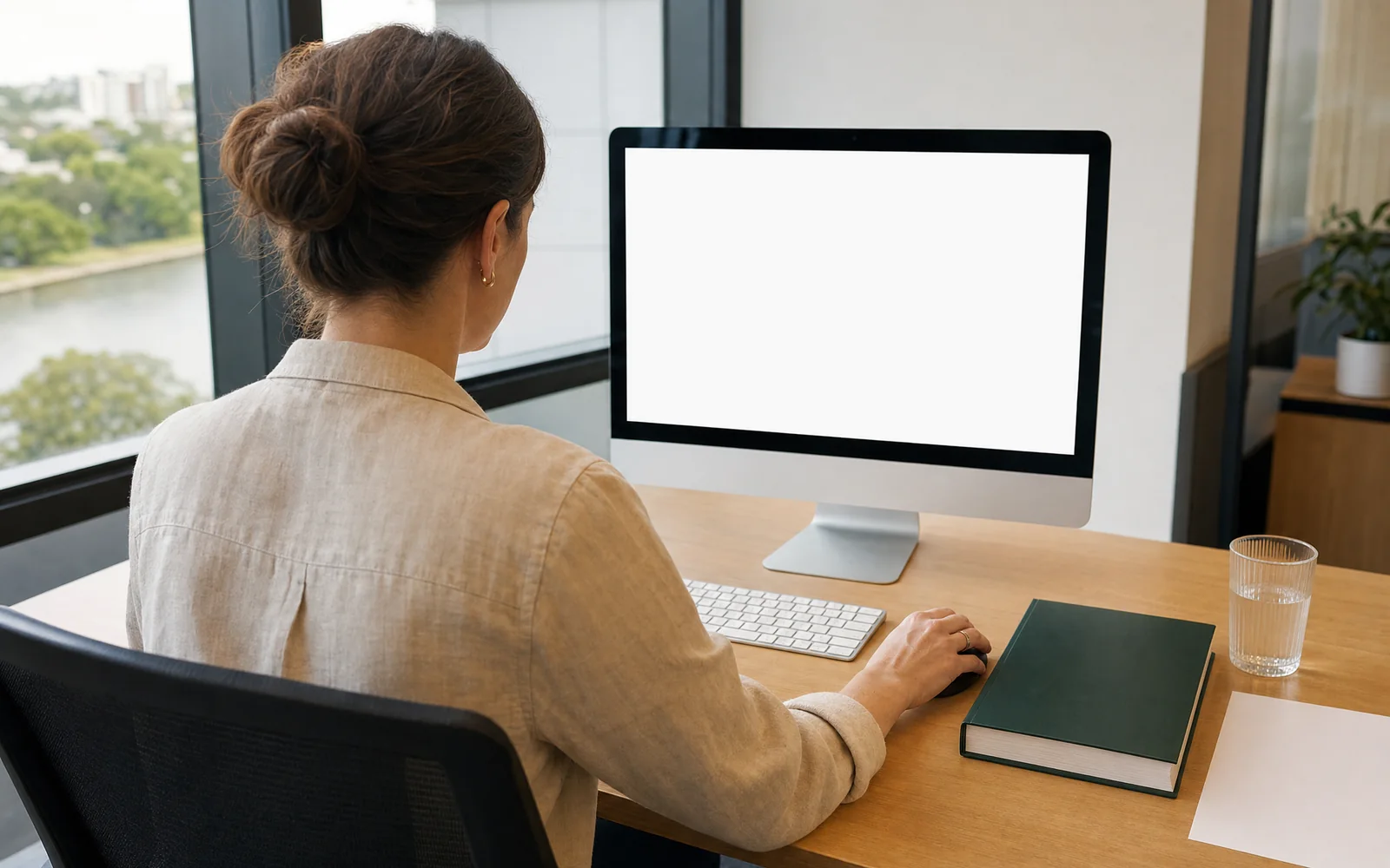 A governance professional reviewing evidence beside a digital workspace